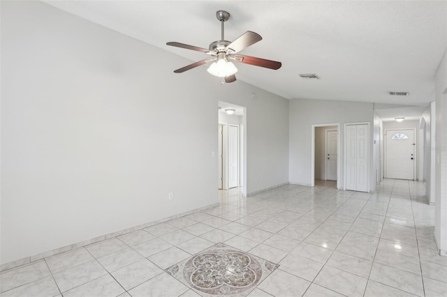 tiled empty room featuring ceiling fan and vaulted ceiling