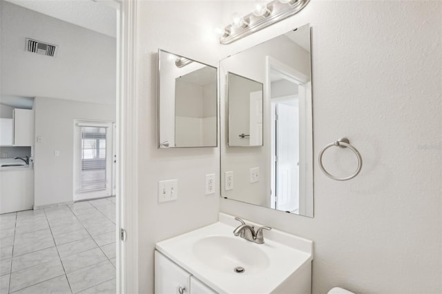 bathroom with washer / clothes dryer and vanity