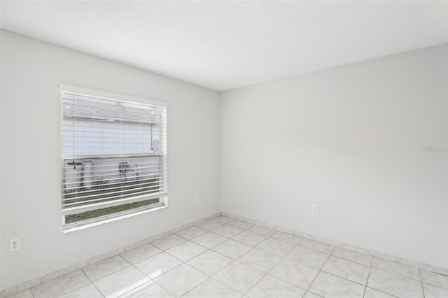 unfurnished room featuring light tile patterned flooring