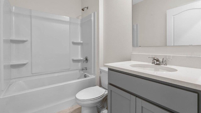 full bathroom with vanity, tub / shower combination, and toilet