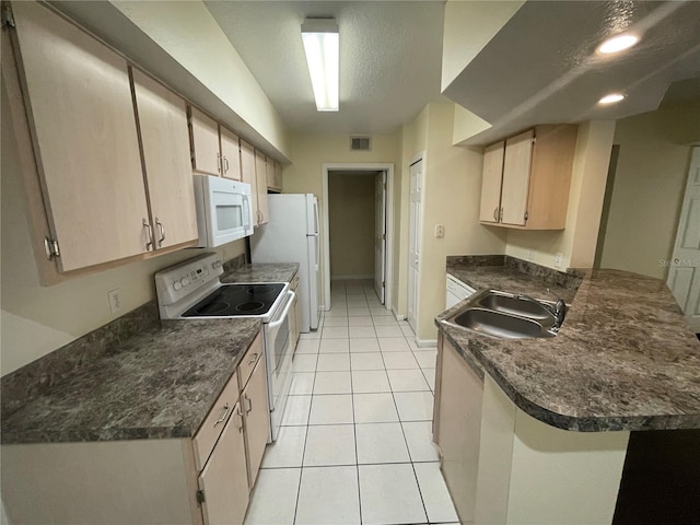 kitchen featuring light tile patterned flooring, kitchen peninsula, light brown cabinets, sink, and white appliances