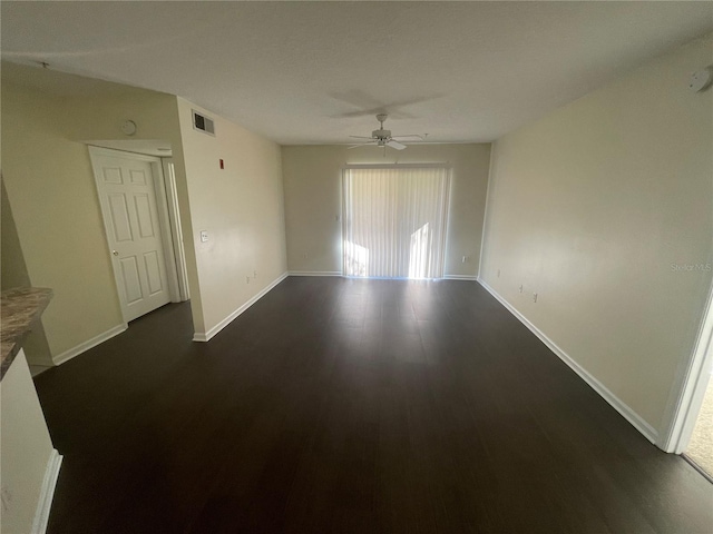 spare room featuring dark hardwood / wood-style flooring and ceiling fan