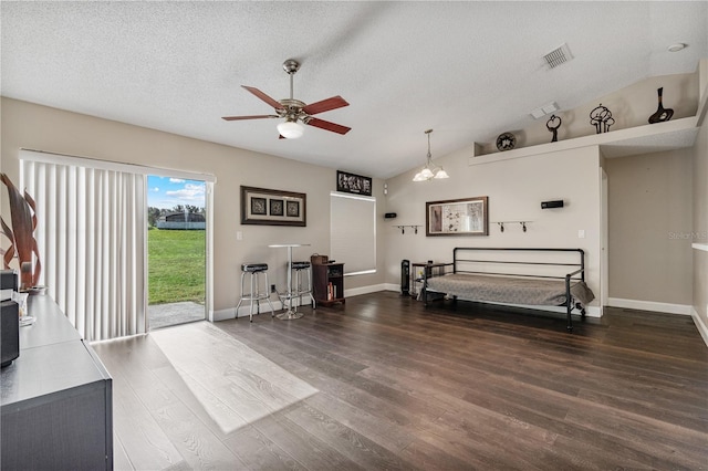 living room featuring a textured ceiling, ceiling fan with notable chandelier, dark hardwood / wood-style floors, and vaulted ceiling