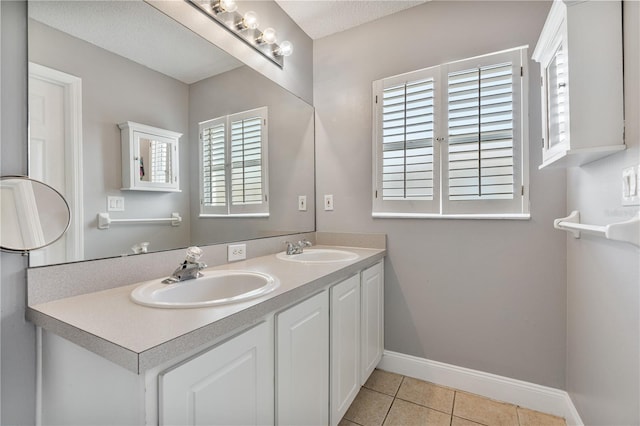 bathroom featuring tile patterned flooring, vanity, and a textured ceiling