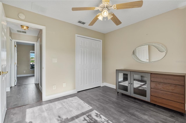 unfurnished bedroom with a closet, wood-type flooring, and ceiling fan