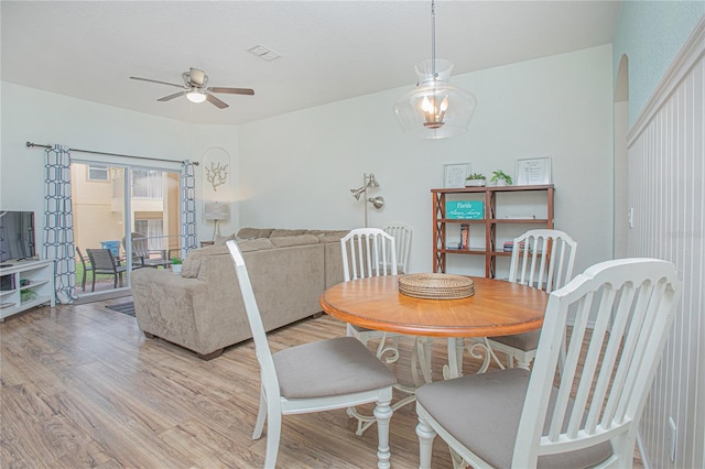 dining space with ceiling fan and light wood-type flooring