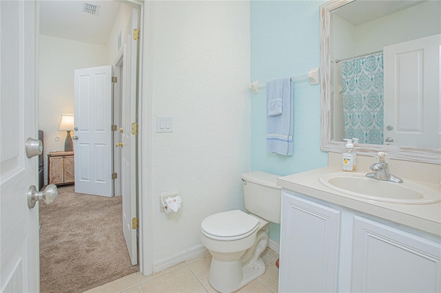 bathroom featuring toilet, vanity, and tile patterned floors