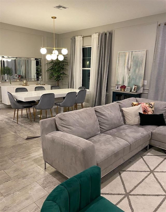 living room featuring light hardwood / wood-style flooring and a chandelier