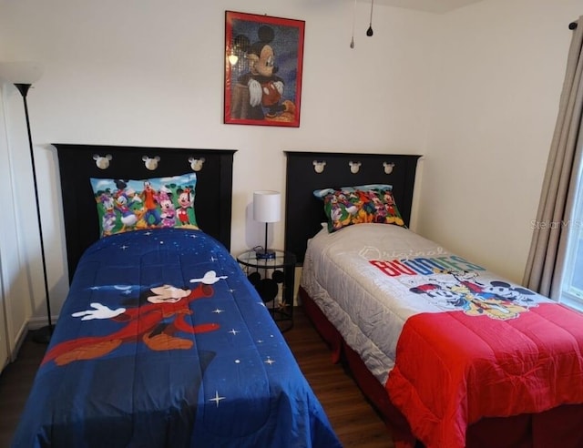 bedroom with dark hardwood / wood-style floors