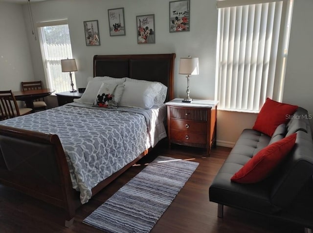 bedroom with dark hardwood / wood-style floors