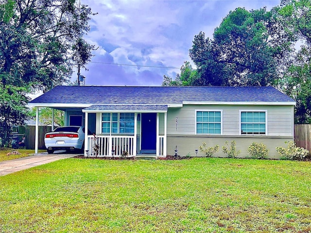 ranch-style house featuring a front yard and covered porch