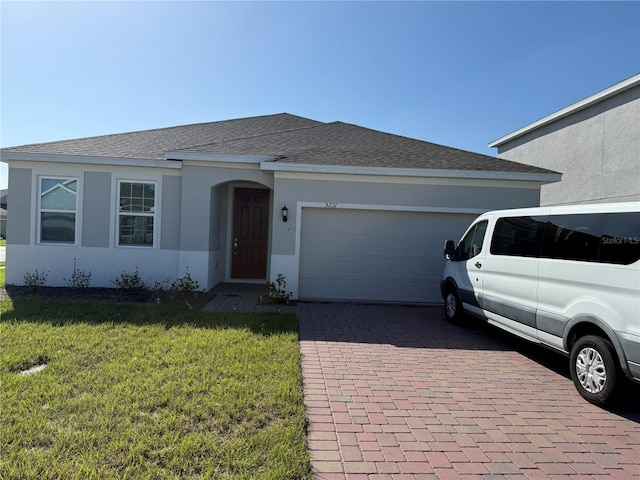 ranch-style house with a garage and a front lawn