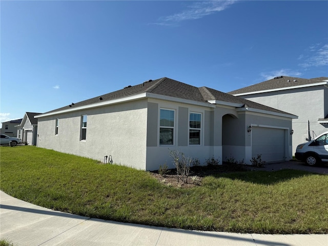 view of side of home with a yard and a garage