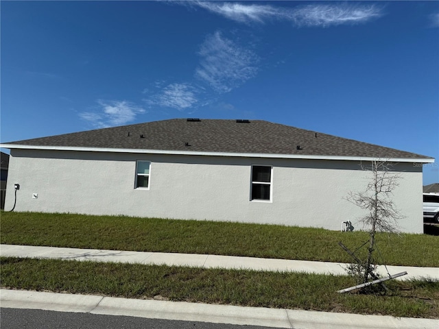 view of property exterior with a yard