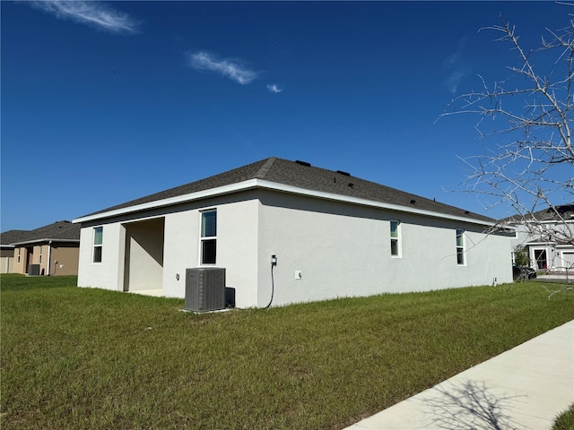 view of home's exterior featuring central AC and a yard