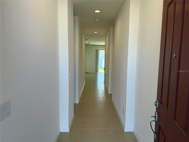 corridor with light tile patterned floors