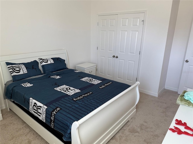 bedroom featuring light carpet and a closet