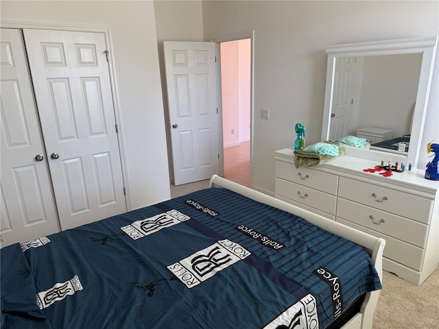 bedroom with light carpet and a closet