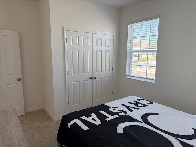 carpeted bedroom featuring a closet