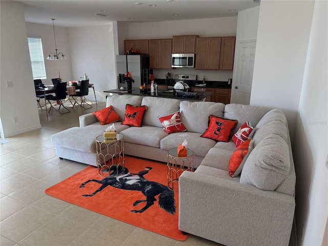 living room featuring light tile patterned flooring and an inviting chandelier