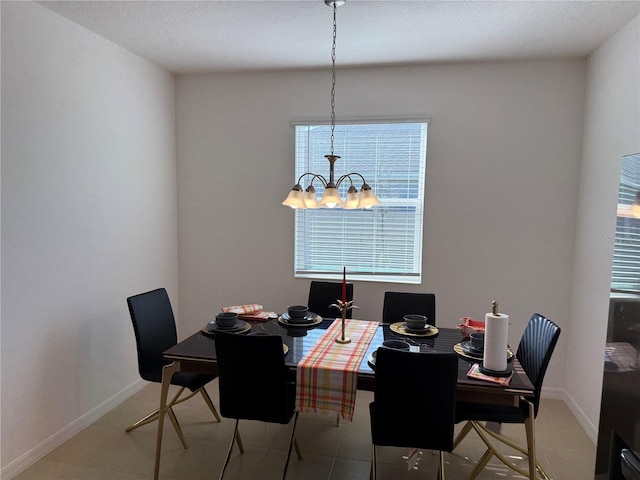 tiled dining room with a notable chandelier