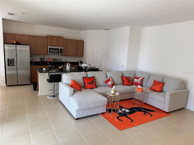 living room with light tile patterned floors and a textured ceiling