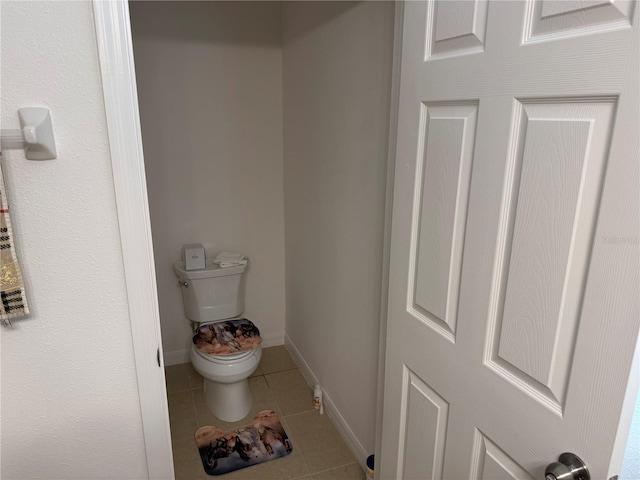 bathroom with tile patterned flooring and toilet