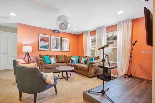 living room with a textured ceiling and hardwood / wood-style flooring