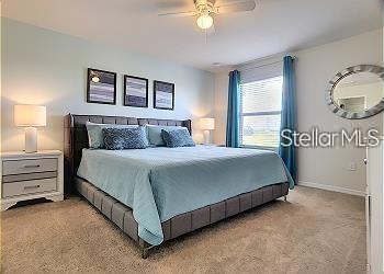 carpeted bedroom featuring ceiling fan