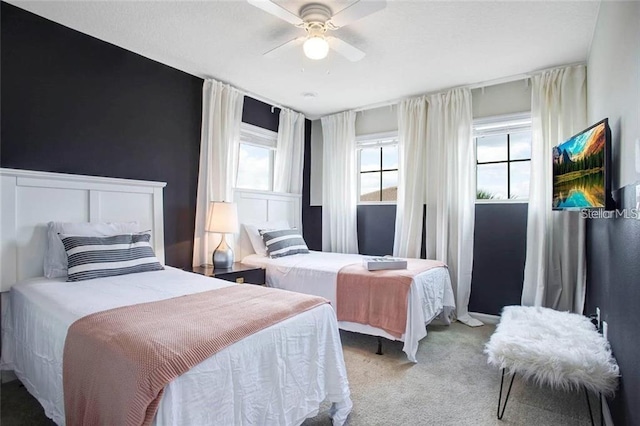 bedroom featuring ceiling fan and light carpet