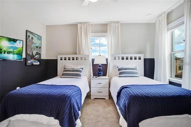 bedroom featuring light colored carpet and ceiling fan