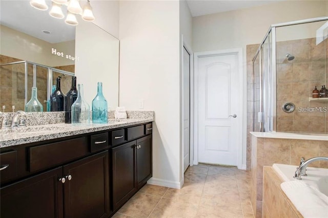 bathroom featuring vanity, tile patterned floors, and separate shower and tub