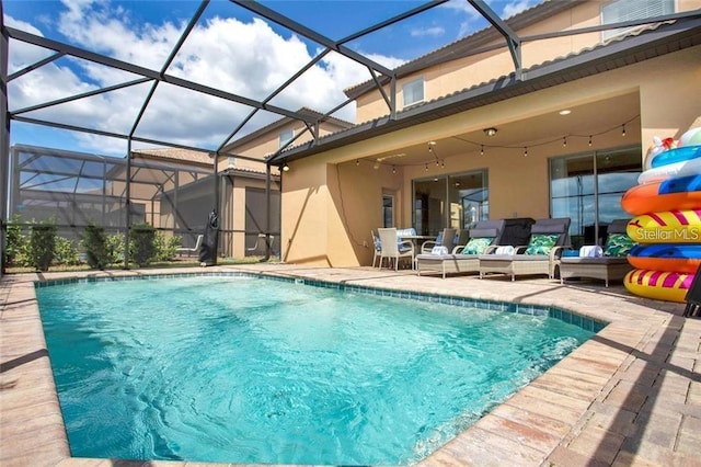 view of swimming pool with glass enclosure and a patio