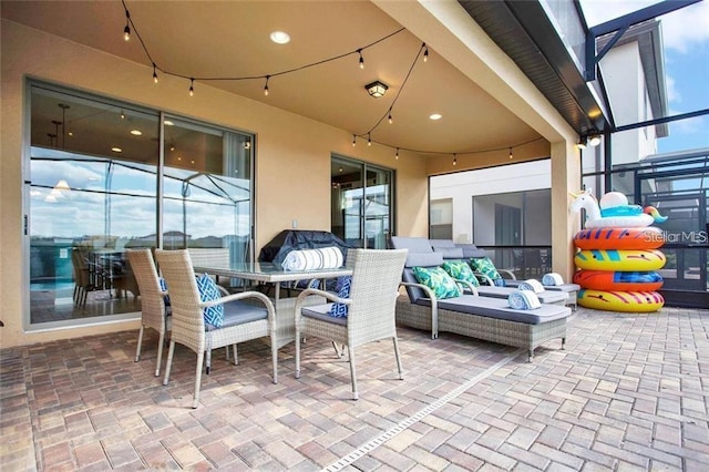 view of patio / terrace featuring outdoor lounge area and a lanai