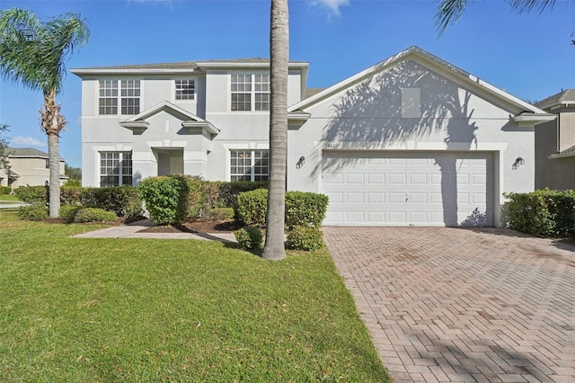 view of front of property with a garage and a front lawn