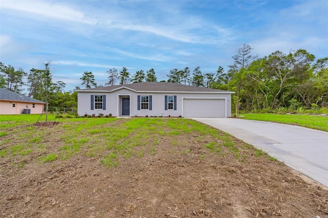 ranch-style home with a garage and a front lawn