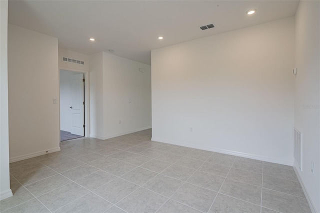 spare room featuring light tile patterned flooring