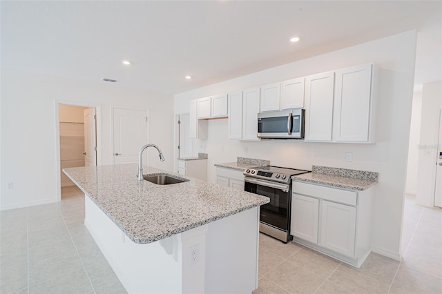 kitchen featuring white cabinetry, a kitchen island with sink, and appliances with stainless steel finishes