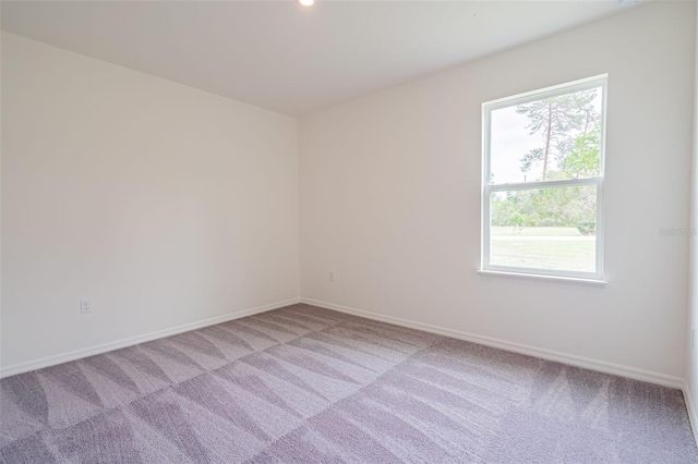 spare room featuring light colored carpet