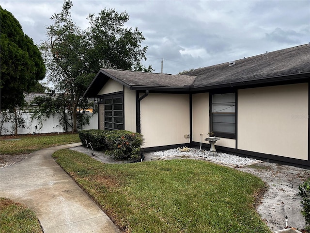 view of property exterior with a lawn