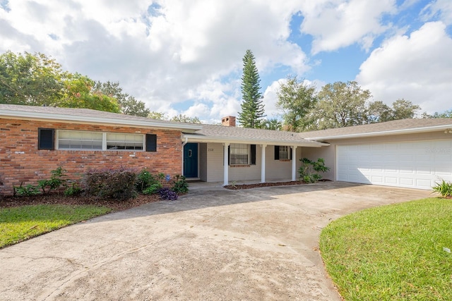 2518 Sweetwater Trl, Winter Park, FL 32789 - ranch-style home with driveway, a chimney, an attached garage, covered porch, and brick siding