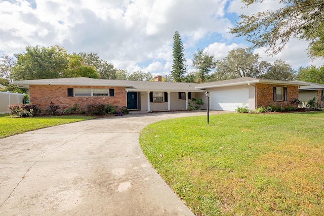 single story home featuring a front lawn and a garage