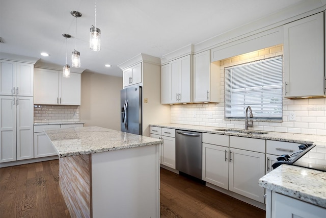 kitchen featuring stainless steel appliances, dark hardwood / wood-style flooring, a center island, sink, and white cabinetry