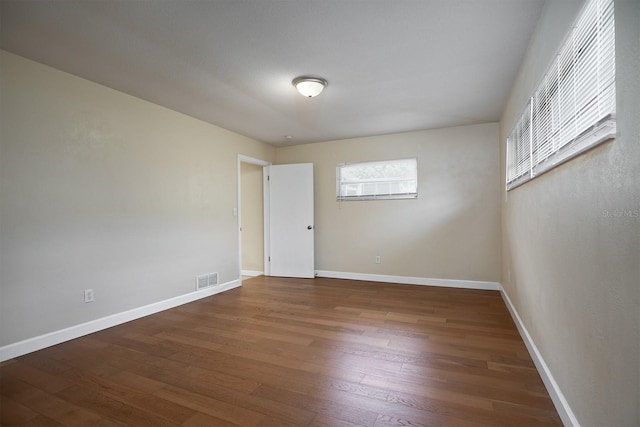 unfurnished room featuring dark hardwood / wood-style flooring