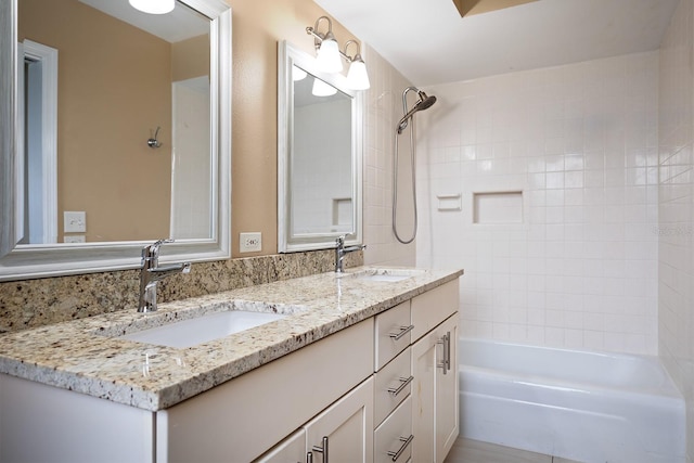 bathroom with vanity and tiled shower / bath