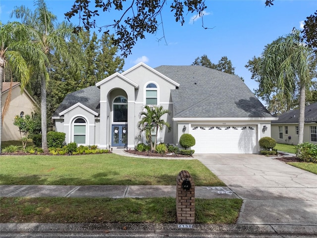 view of front of home with a garage and a front yard