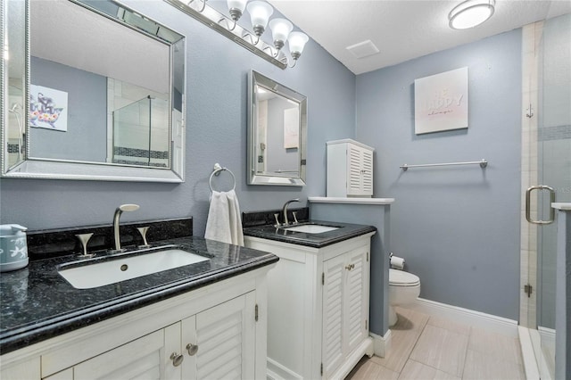 bathroom with vanity, a textured ceiling, an enclosed shower, tile patterned flooring, and toilet