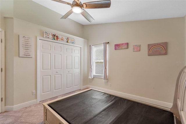 unfurnished bedroom featuring light carpet, lofted ceiling, ceiling fan, and a closet