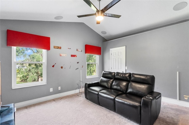 carpeted home theater room featuring plenty of natural light, ceiling fan, and vaulted ceiling