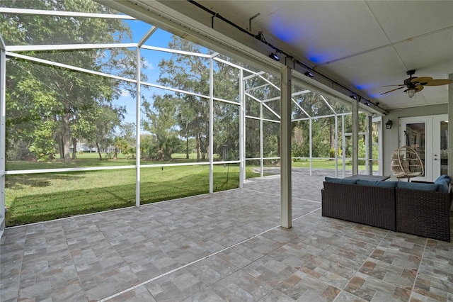 unfurnished sunroom with ceiling fan